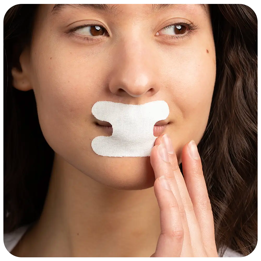 Person with a white adhesive strip on their upper lip.